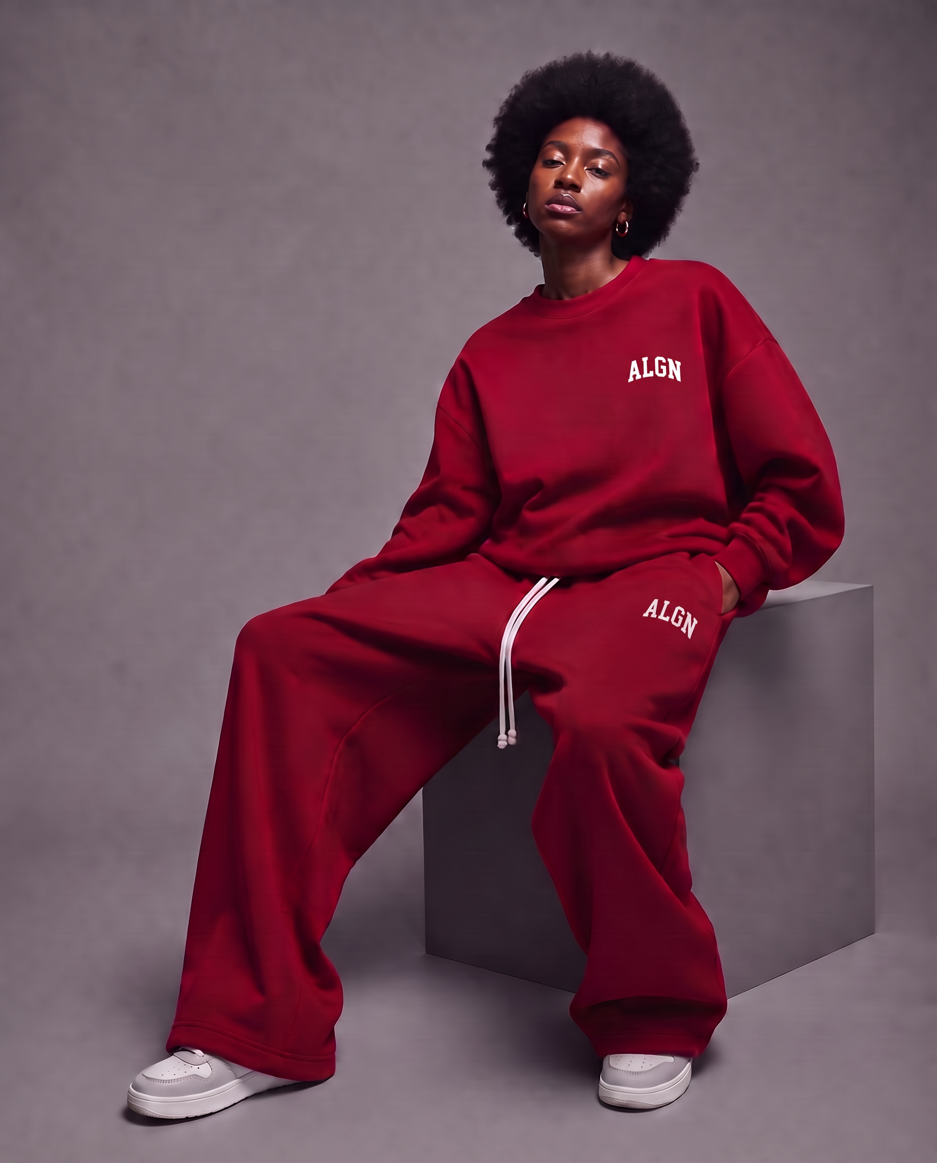 Model seated wearing the ALGN Signature set in red