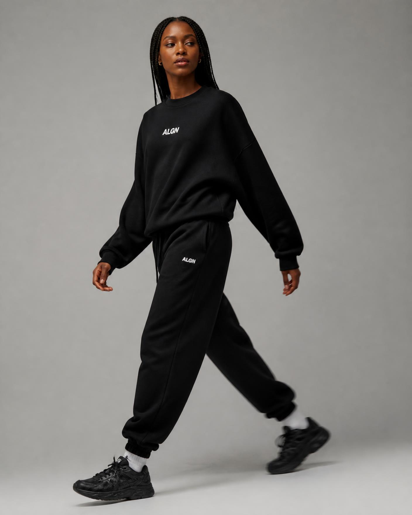 Model walking in the ALGN Signature jogger set in black