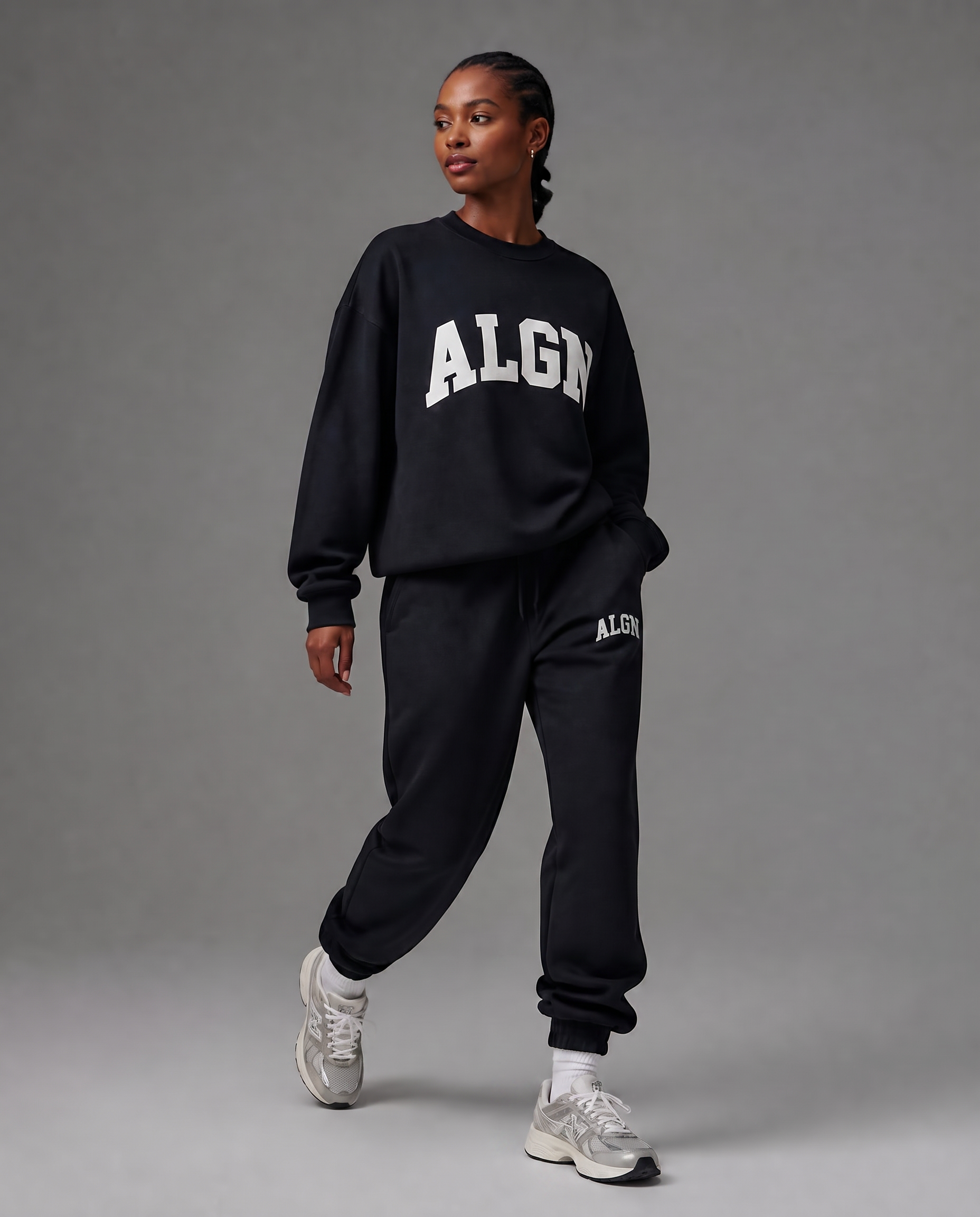 Model walking in the ALGN Collegiate jogger set in black